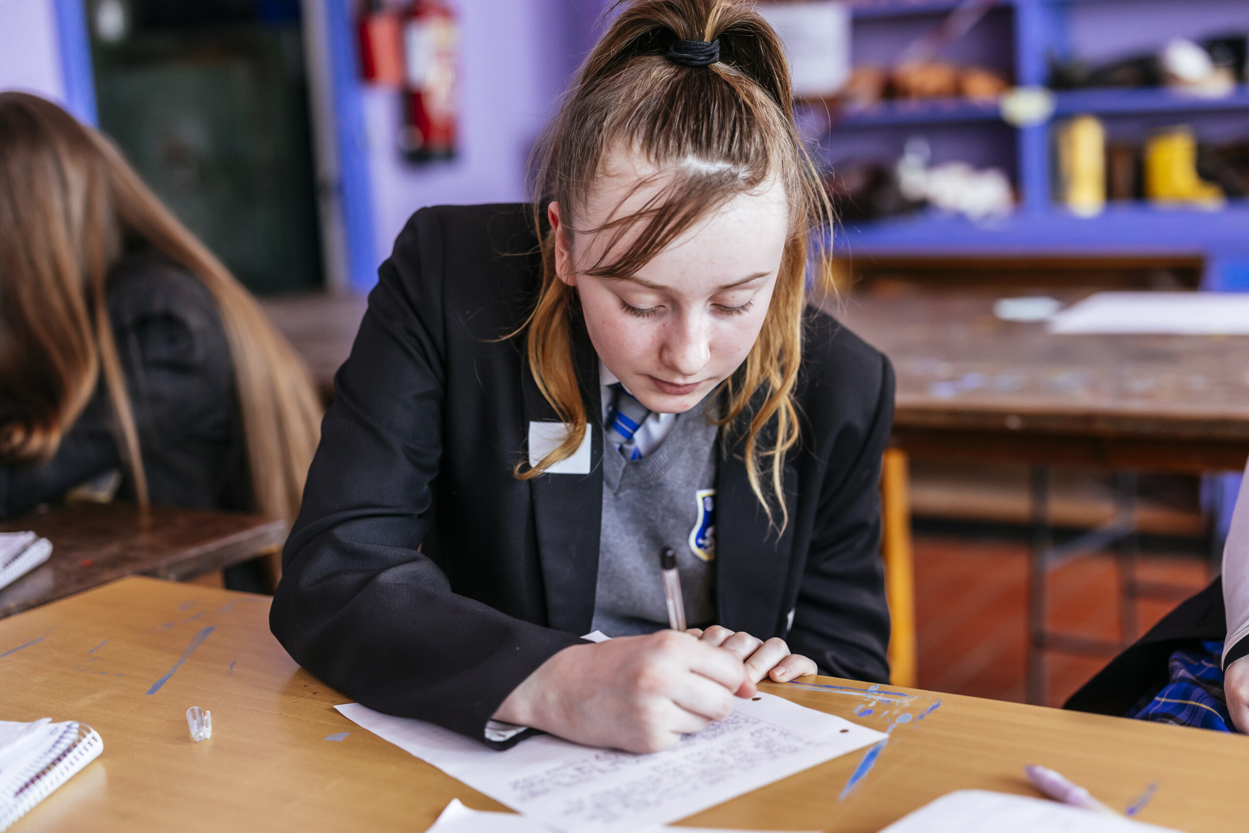 student writing on paper