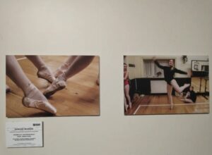 Two photos hanging on a wall at exhibition 